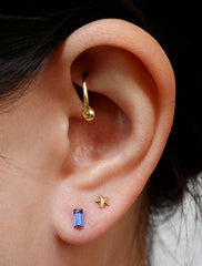 micro sapphire baguette stud earrings modelled, september birthstone