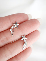 silver shooting star earrings in hand