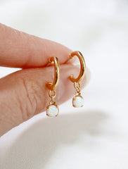 opal charm hoop earrings in hand
