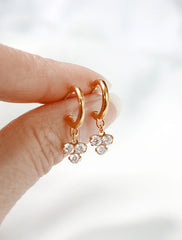 trefoil charm hoop stud earrings in hand