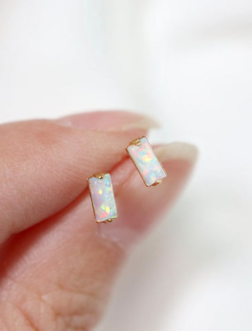 micro opal baguette studs held in hand