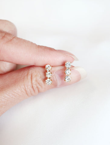 crystal triple bar stud earrings in hand