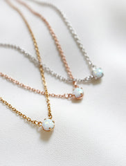 close up of opal necklace in gold, rose gold, silver