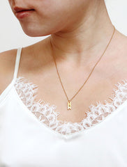 gold ribbon tag necklace modelled