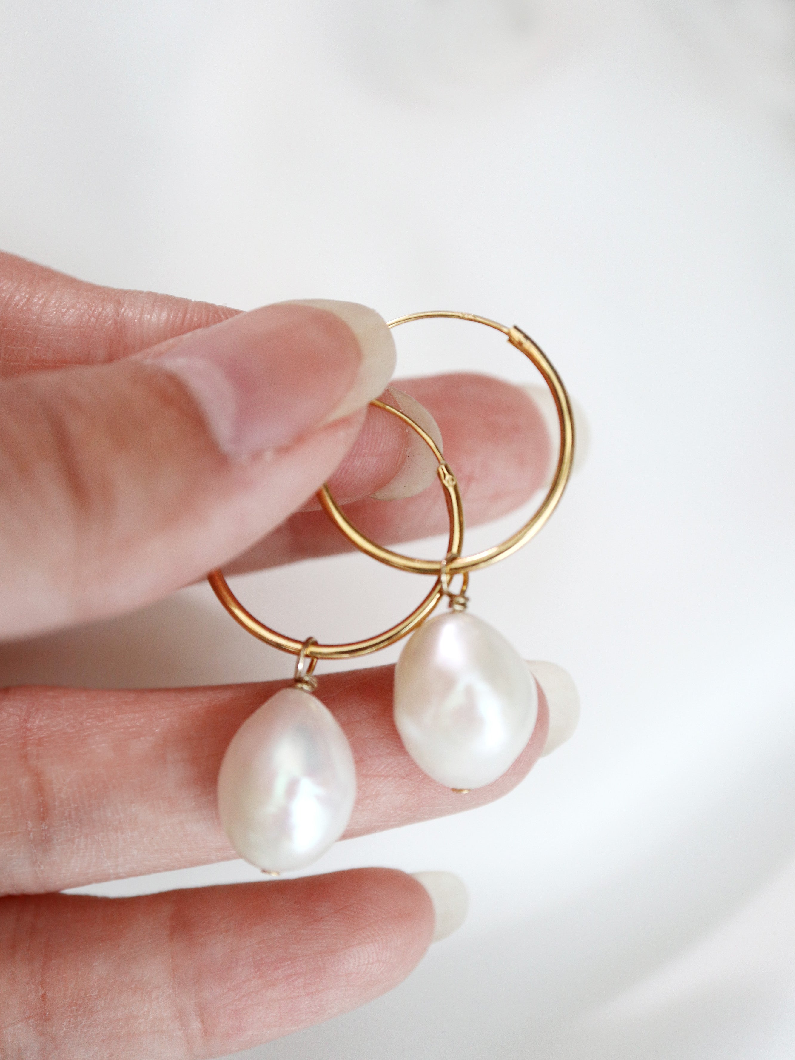 gold filled baroque pearl hoop earrings in hand