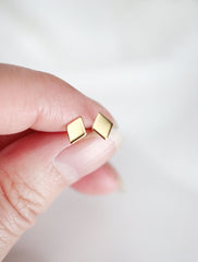 gold filled diamond stud earrings in hand