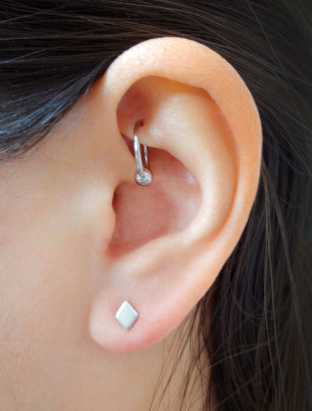 silver diamond stud earrings modelled