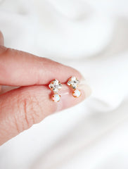 crystal and opal stud earrings in hand
