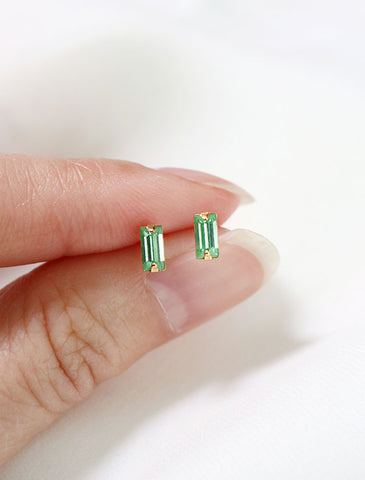 micro peridot baguette earrings in hand, august birthstone