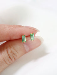 micro peridot baguette earrings in hand, august birthstone