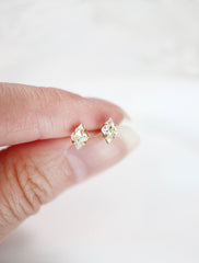 tiny crystal diamond stud earrings in hand