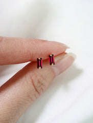 micro garnet baguette stud earrings in hand, january birthstone