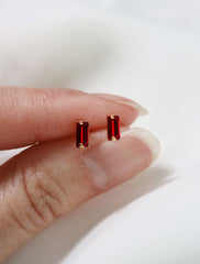 micro ruby baguette studs in hand, july birthstone