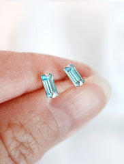 micro aquamarine baguette studs in hand, march birthstone