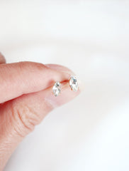 micro marquis stud earrings in hand