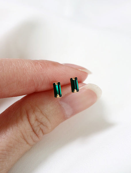 micro emerald baguette studs in hand, may birthstone