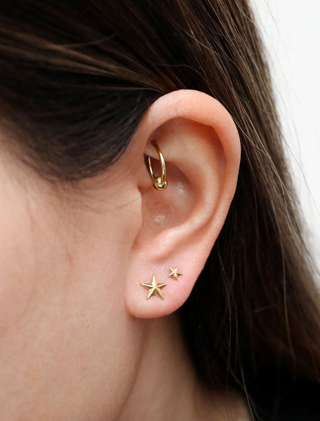 stacked gold star stud earrings modelled in mini and micro