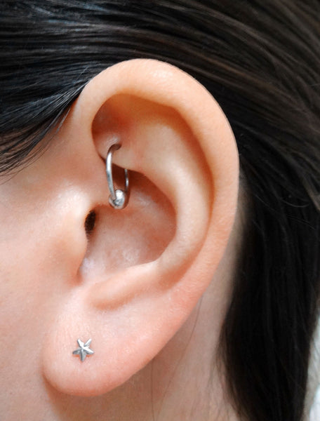 sterling silver micro star stud earrings modelled