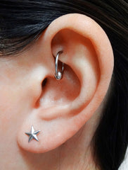 mini star stud earrings modelled in silver