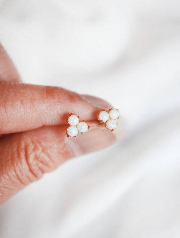 opal trefoil stud earrings in hand