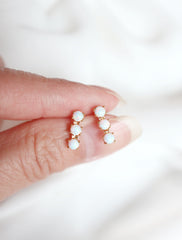 triple opal bar stud earrings in hand
