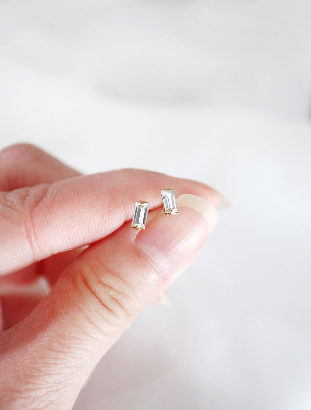 tiny crystal baguette earrings in hand