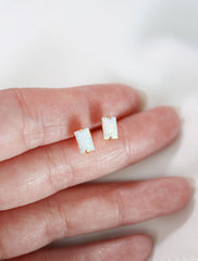 white opal baguette earrings in hand