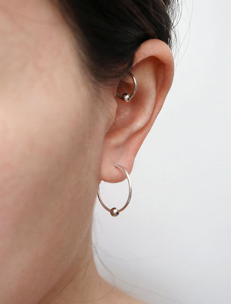 large sterling silver huggie hoop earrings with bead modelled