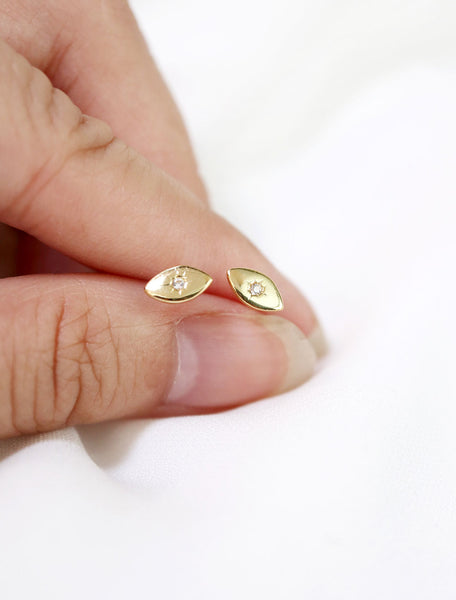 gold vermeil evil eye earrings in hand
