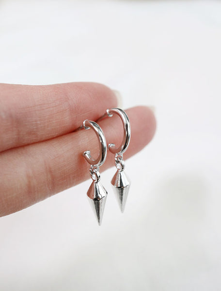 sterling silver spike charm earrings in hand