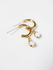close up of dangly white opal hoop stud earrings