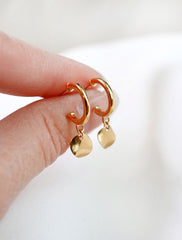 gold vermeil wavy disc hoop earrings in hand