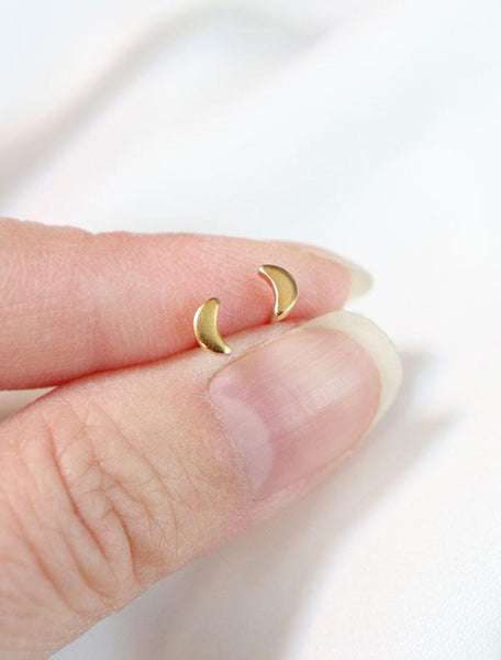 gold vermeil tiny moon earrings in hand