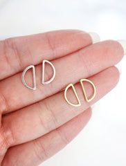open half moon studs in hand