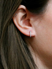 pave huggie hoop earrings modeled