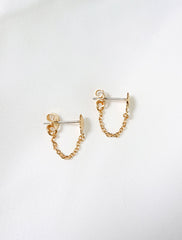 side view of chained seashell stud earrings