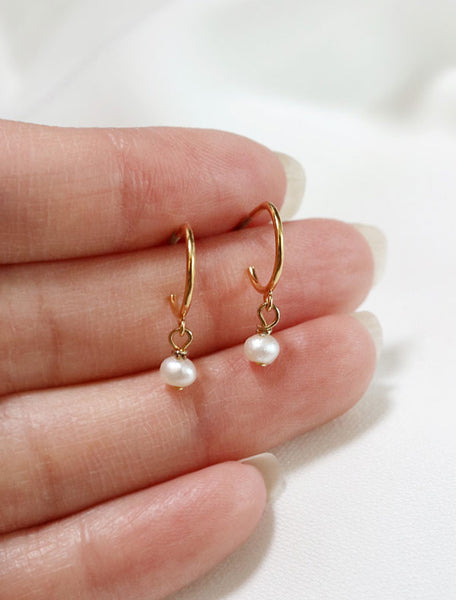 tiny pearl charm hoop earrings in hand
