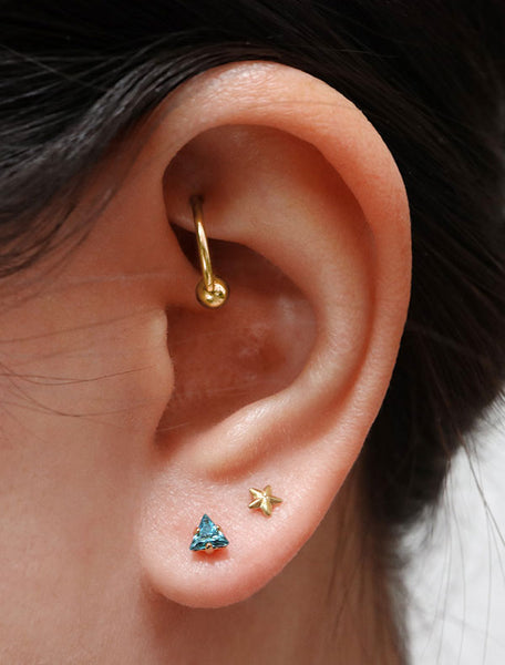 tiny blue topaz triangle earrings modelled