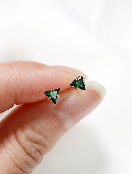 tiny emerald triangle stud earrings in hand, may birthstone