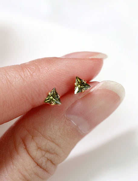 tiny olivine triangle stud earrings in hand, august birthstone
