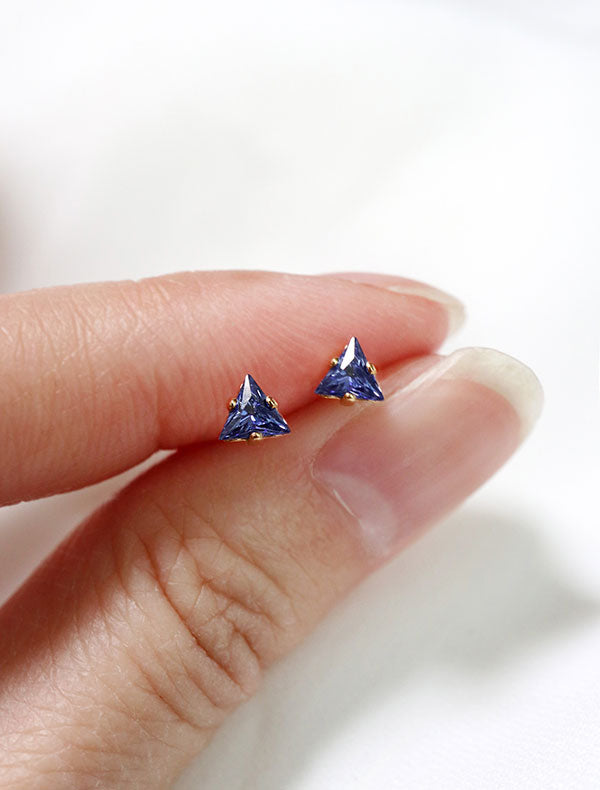tiny sapphire triangle stud earrings in hand, september birth stone