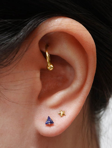 tiny sapphire triangle stud earrings modelled, september birth stone