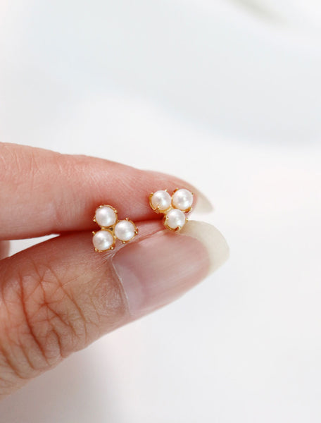 pearl trefoil stud earrings in hand