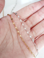 gold and silver bisous lace chain necklaces in hand