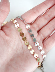 gold and silver large disc chain necklaces in hand