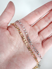 thick figaro chain in hand