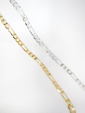 gold and silver thick figaro chain