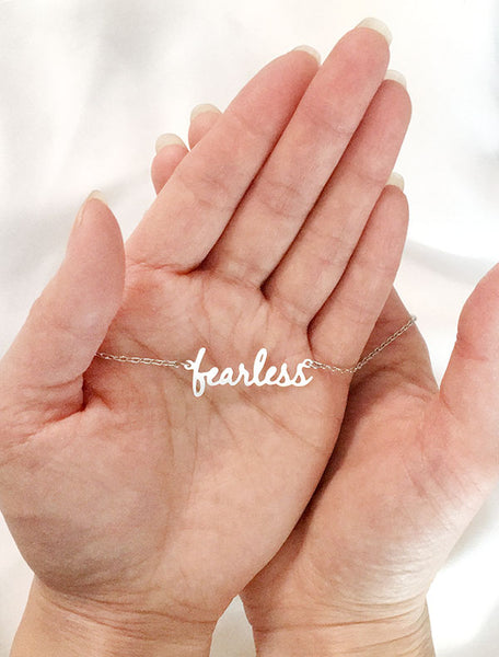 fearless necklace in hand