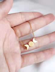 gold filled moon phase necklace in hand