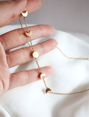 gold filled moon phase necklace in hand